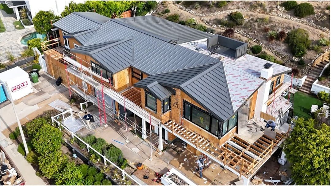 Aerial view of a hillside home addition under construction